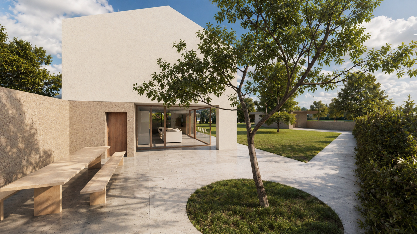 Patio della casa contemporanea con area esterna pavimentata, albero centrale e continuità verso il giardino