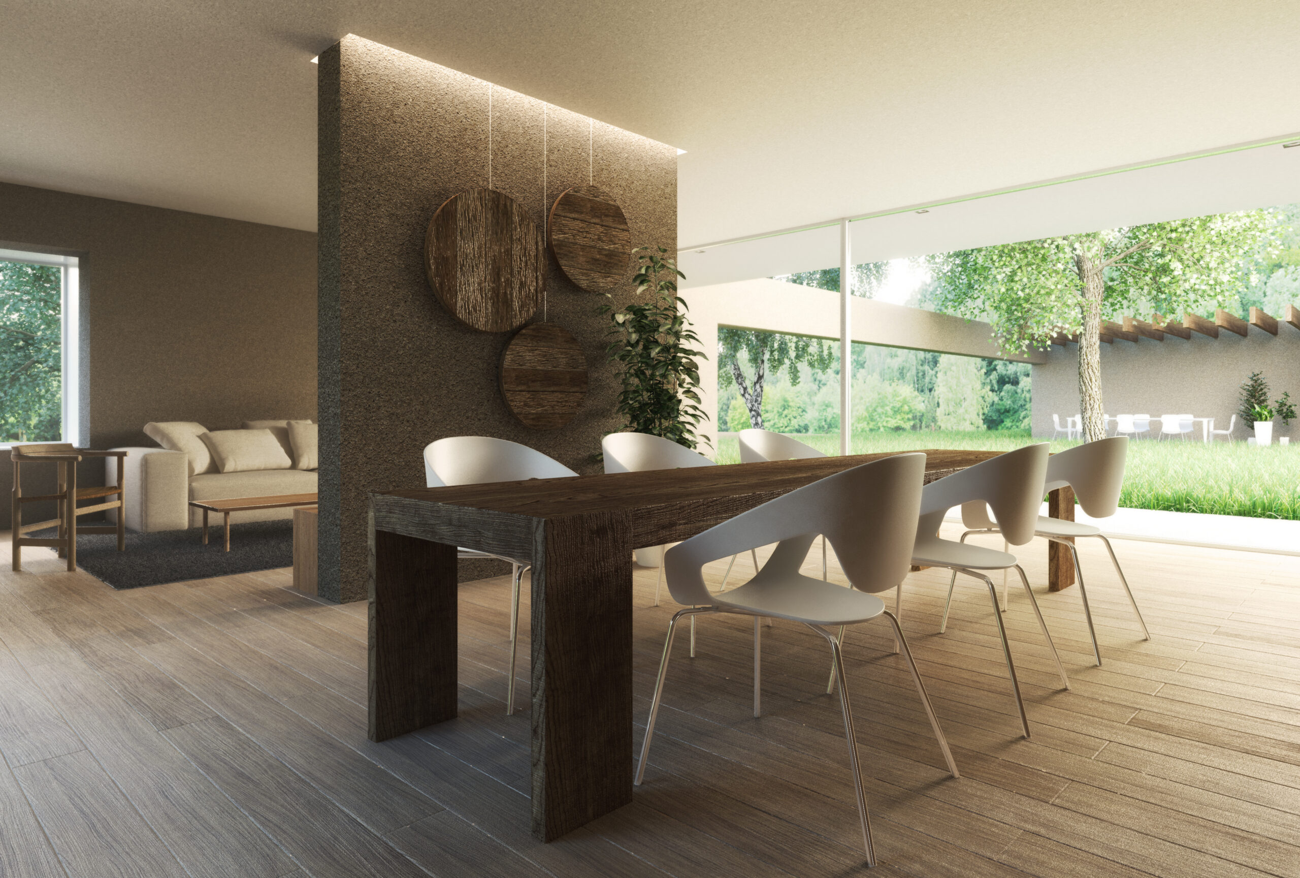 Zona pranzo con grandi vetrate e continuità visiva verso il verde esterno
